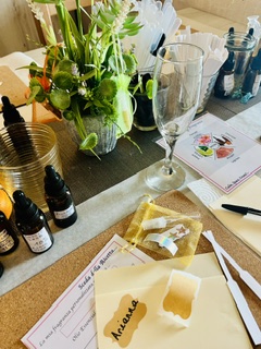 Perfume making workshop table set up with bottles and flowers
